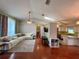 Open-concept living room with hardwood floors and seamless flow to kitchen at 503 Philodendron, Punta Gorda, FL 33955