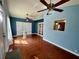 Spacious living room with hardwood floors, blue walls, and vaulted ceiling at 503 Philodendron, Punta Gorda, FL 33955