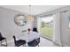 Bright dining area showcasing a modern chandelier, and a view of lush landscaping at 5112 Arlington Rd, Palmetto, FL 34221