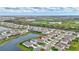 Aerial view showcases a lakeside community with well-maintained homes and lush landscaping, near a golf course at 5313 Halewood Ct, Bradenton, FL 34211