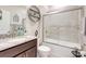 Modern bathroom with a granite vanity top and glass-enclosed shower at 5313 Halewood Ct, Bradenton, FL 34211