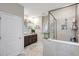 Well-lit bathroom featuring a glass-enclosed shower, granite counters, and modern fixtures, blending style with functionality at 5313 Halewood Ct, Bradenton, FL 34211