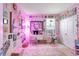 Whimsical bedroom with pink lighting and an array of colorful artwork at 5313 Halewood Ct, Bradenton, FL 34211