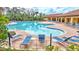Community pool offering inviting lounge seating and beautiful brick features for a calming atmosphere at 5313 Halewood Ct, Bradenton, FL 34211
