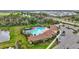 Enjoy a bird's-eye view of the community pool with surrounding trees and nearby parking at 5313 Halewood Ct, Bradenton, FL 34211