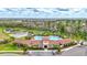Stunning aerial view of the community pool, surrounded by palm trees and lush landscaping at 5313 Halewood Ct, Bradenton, FL 34211