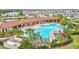 Large, inviting community pool surrounded by palm trees and lounge chairs provides a perfect oasis at 5313 Halewood Ct, Bradenton, FL 34211