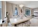 Dining room with white table, chandelier, white curtains, and view of the bedroom at 5313 Halewood Ct, Bradenton, FL 34211