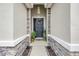 Inviting front door framed by stone accents and lovely plants at 5313 Halewood Ct, Bradenton, FL 34211