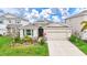 Charming single-story home boasts a manicured lawn, stone accents, and a two-car garage at 5313 Halewood Ct, Bradenton, FL 34211