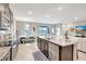 Open kitchen with a granite island and stainless appliances, flowing into a bright dining area and living space at 5313 Halewood Ct, Bradenton, FL 34211