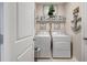 Convenient laundry room with modern machines and decorative shelving at 5313 Halewood Ct, Bradenton, FL 34211