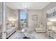 Elegant living room with tile floors, a sparkling chandelier, and comfortable seating bathed in natural light at 5313 Halewood Ct, Bradenton, FL 34211
