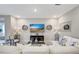 Bright living room featuring an L-shaped white sofa, tile flooring, and decorative accents at 5313 Halewood Ct, Bradenton, FL 34211