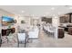Open-concept living room and kitchen with dark wood cabinets, tile flooring, and comfortable white sofa at 5313 Halewood Ct, Bradenton, FL 34211