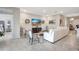 Living room featuring light tile flooring, a large white sofa and a large television at 5313 Halewood Ct, Bradenton, FL 34211