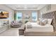 Bright bedroom showcasing waterfront views, a cozy seating area, and sophisticated decor, offering a tranquil escape at 5313 Halewood Ct, Bradenton, FL 34211