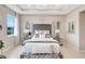 Elegant bedroom featuring a tufted headboard, decorative mirrors, and contemporary lighting, creating a luxurious retreat at 5313 Halewood Ct, Bradenton, FL 34211