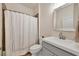 Well-lit bathroom features a vanity with a large mirror and a shower with decorative tile at 5333 Charlie Brown Ln, Sarasota, FL 34233