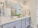 Elegant bathroom featuring a double vanity with white countertops, modern fixtures, and a glass-enclosed shower at 5333 Charlie Brown Ln, Sarasota, FL 34233