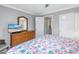 Bedroom featuring a television with a dresser, closet, and access to laundry closet and bathroom at 5892 17Th W St # C25, Bradenton, FL 34207
