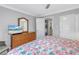 Comfortable bedroom with a large dresser, television, and access to the laundry closet and bathroom at 5892 17Th W St # C25, Bradenton, FL 34207