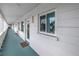 Inviting condo featuring a cozy entryway with a decorative pineapple and a well-lit corridor at 5892 17Th W St # C25, Bradenton, FL 34207