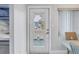 Charming front door with glass panel offering views of the outside from the beautifully decorated interior at 5892 17Th W St # C25, Bradenton, FL 34207