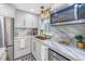 Updated kitchen featuring white cabinets, marble countertops, and stainless steel appliances at 5892 17Th W St # C25, Bradenton, FL 34207