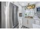 Modern kitchen design with stainless steel refrigerator, marble countertops, and elegant gold accents at 5892 17Th W St # C25, Bradenton, FL 34207