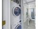 Convenient in-unit laundry area with a stacked washer and dryer next to the bathroom at 5892 17Th W St # C25, Bradenton, FL 34207