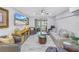 Cozy living room featuring modern furniture, a large television, and a view of the community pool at 5892 17Th W St # C25, Bradenton, FL 34207