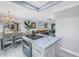 Bright open-concept living space featuring a modern kitchen island, dining area, and comfortable living room at 5892 17Th W St # C25, Bradenton, FL 34207