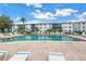 Well-maintained community pool with clear blue water, surrounded by comfortable lounge chairs, creating a resort-like atmosphere at 5892 17Th W St # C25, Bradenton, FL 34207