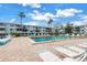 Beautiful community pool surrounded by lounge chairs and palm trees, perfect for relaxation and recreation at 5892 17Th W St # C25, Bradenton, FL 34207