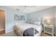 Cozy bedroom features a wrought iron bed, side tables, and light blue walls at 6079 Ravenwood Dr, Sarasota, FL 34243