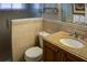 Tiled bathroom with a glass shower, toilet, and vanity, exuding a comfortable and inviting ambiance at 6140 Midnight Pass Rd # A10, Sarasota, FL 34242