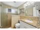 Bathroom with glass-doored shower, granite vanity, and tile walls, offering a clean and functional space at 6140 Midnight Pass Rd # A10, Sarasota, FL 34242