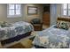Bedroom with two twin beds and a comfortable armchair at 6140 Midnight Pass Rd # A10, Sarasota, FL 34242