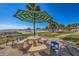 Charming outdoor community area with stone table, seating, and a view of the beach at 6140 Midnight Pass Rd # A10, Sarasota, FL 34242