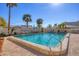 Community pool featuring clear blue water, lounge chairs, palm trees, and a well-maintained deck at 6140 Midnight Pass Rd # A10, Sarasota, FL 34242