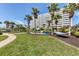 Beautiful courtyard with lush lawn, palm trees, and inviting hammock, perfect for relaxation at 6140 Midnight Pass Rd # A10, Sarasota, FL 34242
