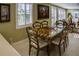 Dining room with a glass top table, seating for six and plantation shutters at 6140 Midnight Pass Rd # A10, Sarasota, FL 34242