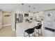 Bright kitchen featuring a quartz island with seating, stainless steel appliances, and modern cabinetry at 6140 Midnight Pass Rd # A10, Sarasota, FL 34242
