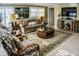 Comfortable living room with neutral colors and a round wicker table at 6140 Midnight Pass Rd # A10, Sarasota, FL 34242