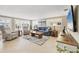 Bright living room featuring comfortable seating, neutral decor, and ample natural light from plantation-shuttered windows at 6140 Midnight Pass Rd # A10, Sarasota, FL 34242