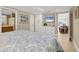 Serene bedroom with a TV, storage dresser, and an open doorway to the inviting living room at 6140 Midnight Pass Rd # A10, Sarasota, FL 34242