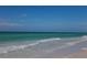 Serene ocean view with gentle waves lapping the shore and a clear blue sky above at 6140 Midnight Pass Rd # A10, Sarasota, FL 34242