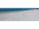 Beautiful sandy beach with clear water, ideal for walking and enjoying the ocean breeze at 6140 Midnight Pass Rd # A10, Sarasota, FL 34242