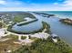 Wide aerial shot of a calm inlet and boat ramp in this coastal community at 645 Palmetto Dr, Venice, FL 34293